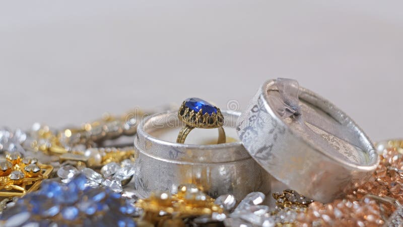 Antique ring with blue gemstone in box and jewel set. Beautiful fashion and vintage jewelry with precious shiny stones, pearls and