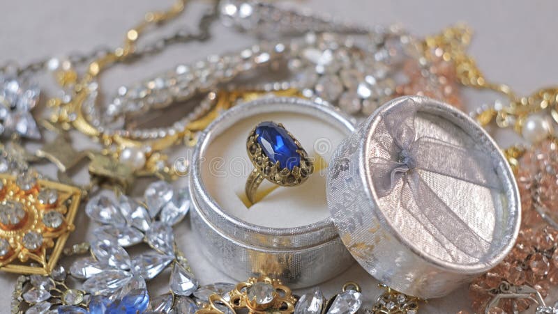 Antique ring with blue gemstone in box and jewel set. Beautiful fashion and vintage jewelry with precious shiny stones, pearls and