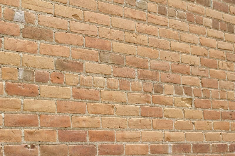 Antique sandy brown clay brick wall texture with a weathered and worn look royalty free stock photography Antique sandy brown clay brick wall texture with a weathered and worn look royalty free stock photography
