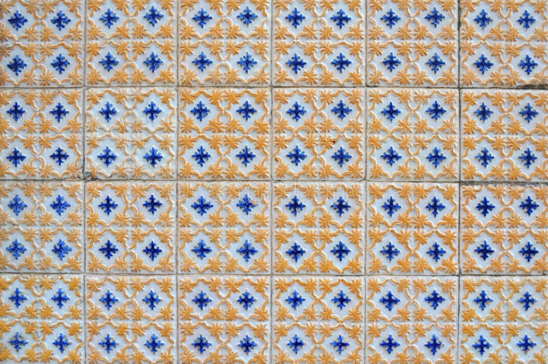 Vintage portuguese textured blue and yellow tiles on an exterior wall on Figueira da Foz, Portugal. Vintage portuguese textured blue and yellow tiles on an exterior wall on Figueira da Foz, Portugal.