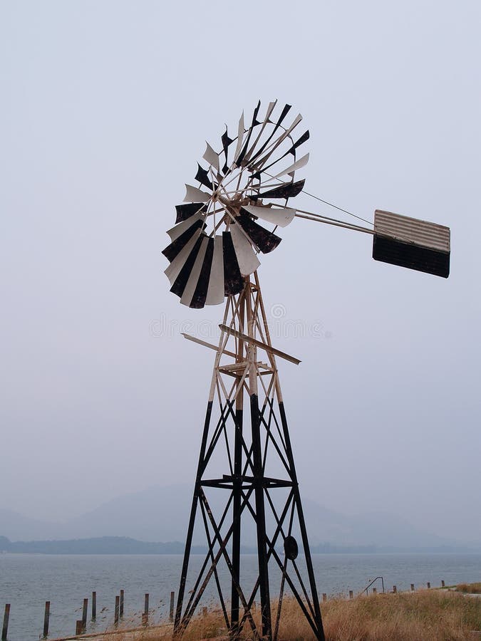 Antique wind mill by the sea