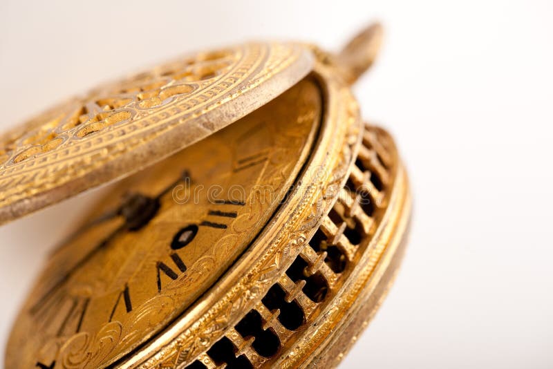 Antique yellow brass pocket watch on white stock image