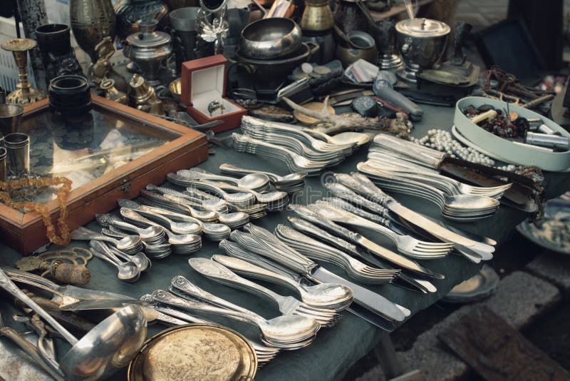 Antiques on flea market or festival, vintage silver cultery - spoons, knifes, forks and other vintage things. Collectibles