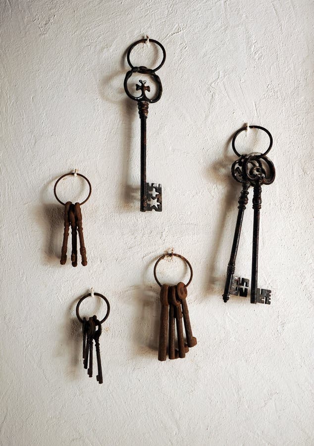 Antiques Iron Keys Hanging on a House Whitewashed Wall Stock Photo