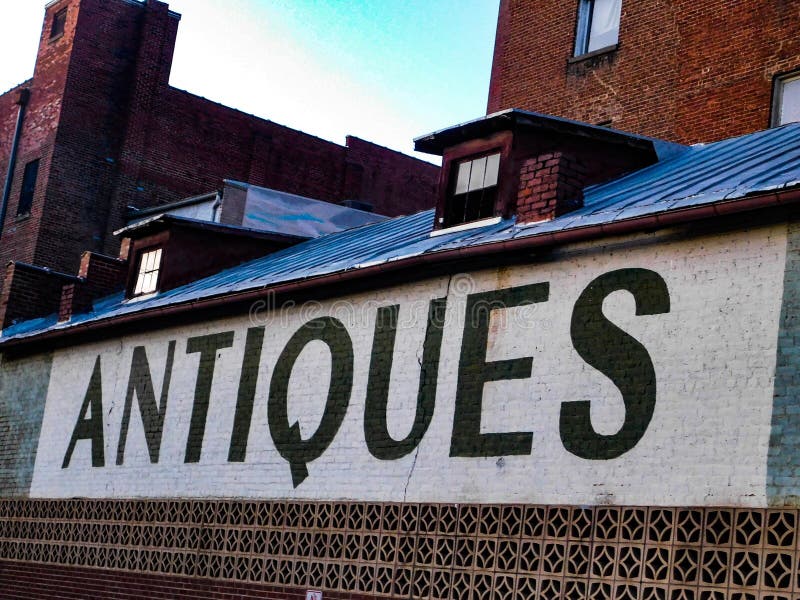 Antiques Sign on the Side of a Building Stock Photo Image of texture