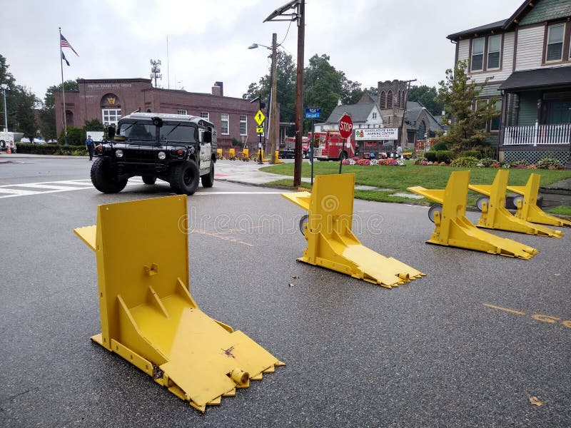 High security in Rutherford, New Jersey, to protect attendees of the 44th Annual Labor Day Street Fair
. This photo was taken in Rutherford, New Jersey, on September 2nd 2019. Anti Terrorism Defense, Meridian Barriers, Labor Day Street Fair, Rutherford, NJ, USA, barricade, barricades, terrorist, terrorists, yellow, steel, hostile, vehicle, vehicles, mitigation, hvm, hummer, law, enforcement, police, officers, rainy, raining, streets, suburban, suburbs, town, towns, small, downtown, block, mobile, homeland, united, states, american, americans, attacks, defend, against, crash, people, protection, bright, blocked, road, roads, roadblock, ram, ramming, combat, stop, stopping. High security in Rutherford, New Jersey, to protect attendees of the 44th Annual Labor Day Street Fair
. This photo was taken in Rutherford, New Jersey, on September 2nd 2019. Anti Terrorism Defense, Meridian Barriers, Labor Day Street Fair, Rutherford, NJ, USA, barricade, barricades, terrorist, terrorists, yellow, steel, hostile, vehicle, vehicles, mitigation, hvm, hummer, law, enforcement, police, officers, rainy, raining, streets, suburban, suburbs, town, towns, small, downtown, block, mobile, homeland, united, states, american, americans, attacks, defend, against, crash, people, protection, bright, blocked, road, roads, roadblock, ram, ramming, combat, stop, stopping