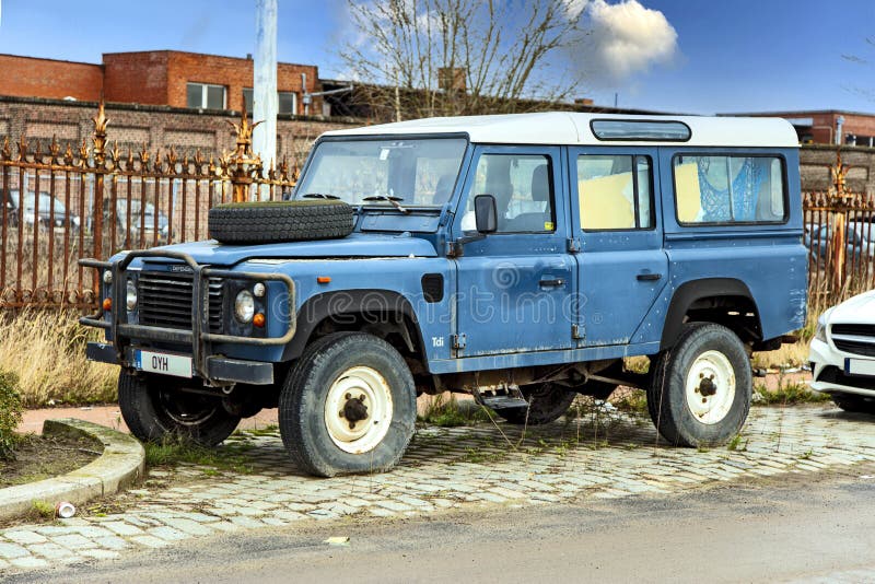 Antwerpen, Belgium - February 5, 2021: Old Land Rover Defender parked on the roadside in Antwerp, slow car destruction