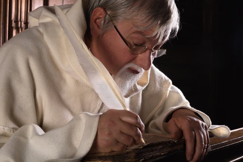 Monk writing in an ancient book with a feather quill. Monk writing in an ancient book with a feather quill