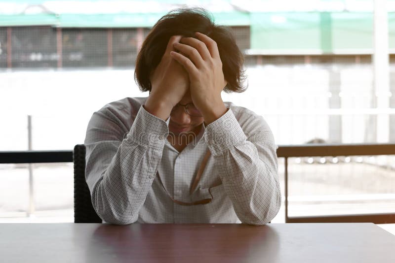 Anxiety stressed Asian business man covering forehead with hands. royalty free stock photo Anxiety stressed Asian business man covering forehead with hands. royalty free stock photo