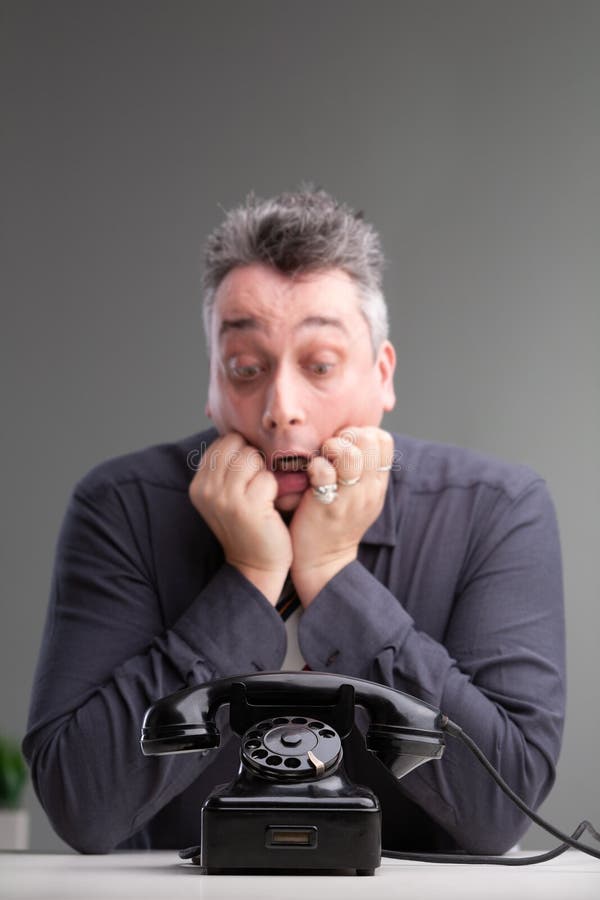 Anxious man looking at a phone in trepidation royalty free stock photos Anxious man looking at a phone in trepidation royalty free stock photos