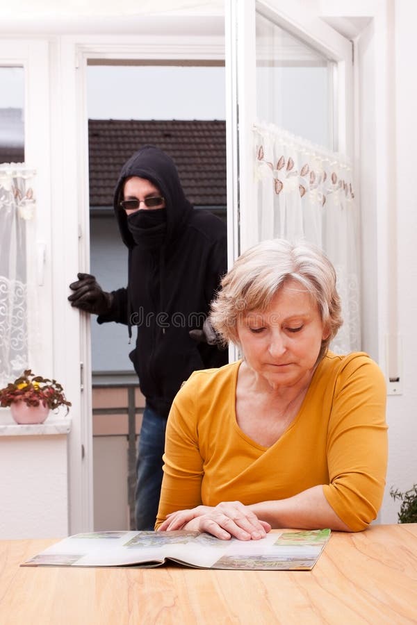 Burglar surprise unwary female senior. Burglar surprise unwary female senior