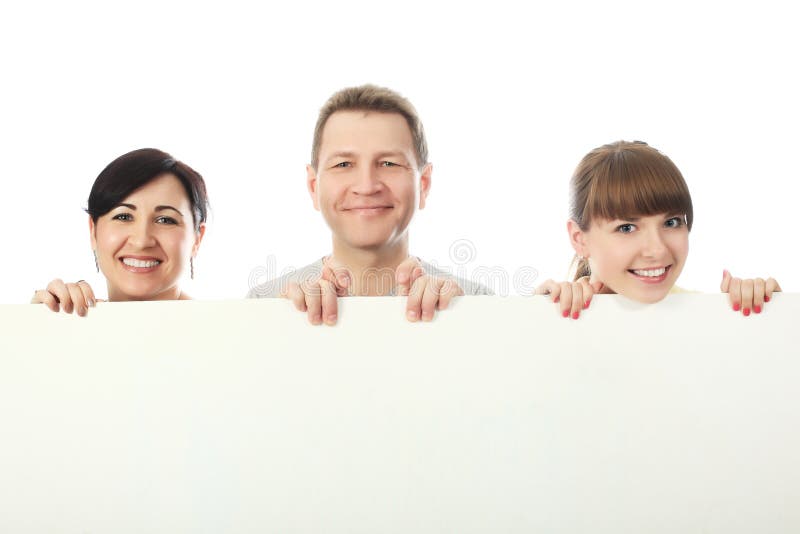 Happy family: parents and their grown-up daughter with a billboard. Happy family: parents and their grown-up daughter with a billboard.