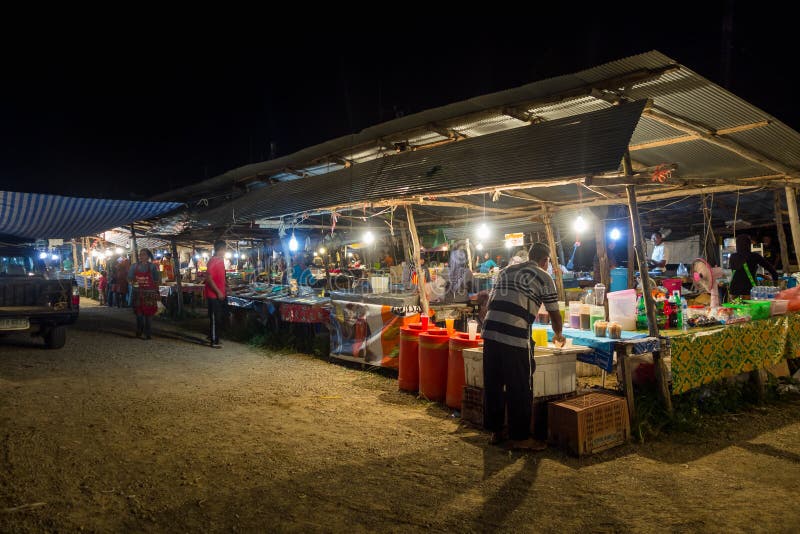 AO NANG, THAILAND - MARCH, 23, 2018: Outdoor view of unidentified people in a public fruit market street food stalls on royalty free stock images AO NANG, THAILAND - MARCH, 23, 2018: Outdoor view of unidentified people in a public fruit market street food stalls on royalty free stock images
