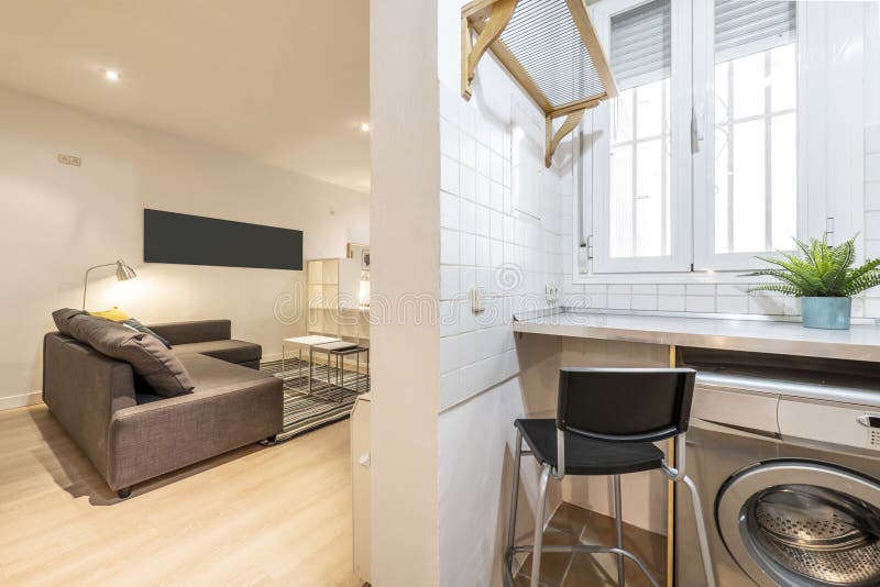 Apartment with a Kitchen without Doors Tiled in White and a Sofa with a