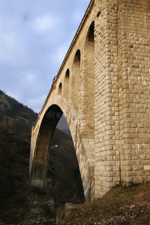 Old stone railroad bridge with big single vault. Old stone railroad bridge with big single vault