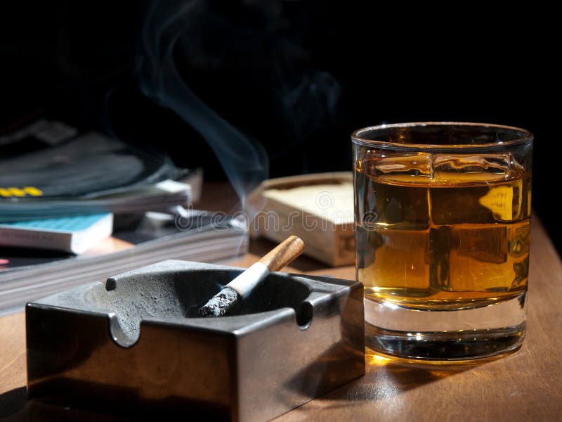 Whisky and cigarettes, unhealthy lifestile, lonely drinking at night. Whisky and cigarettes, unhealthy lifestile, lonely drinking at night