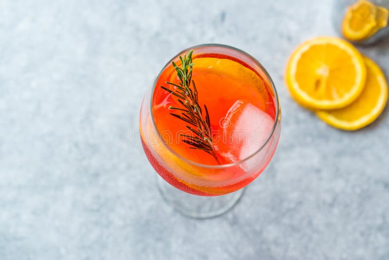 Aperol Spritz Cocktail with Orange Slice, Rosemary and Ice.