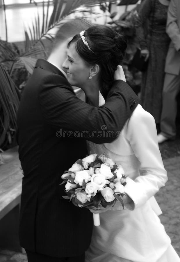 Wedding couple hugging in wedding ceremony. Monochrome image. Wedding couple hugging in wedding ceremony. Monochrome image.