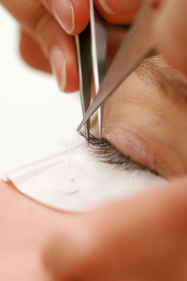 The practitioner applies the new lashes - extends the existing. The practitioner applies the new lashes - extends the existing