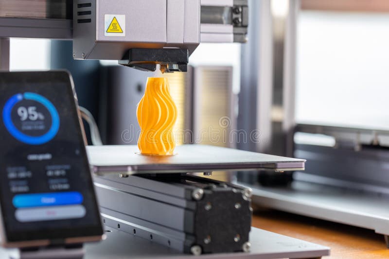 Application for control 3D printer displayed on smartphone. Against the background, a 3D printer prints a detail. Application for control 3D printer displayed on smartphone. Against the background, a 3D printer prints a detail