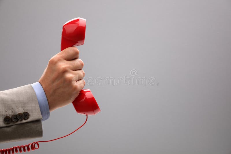 Red phone over gray background concept for customer support line or important call. Red phone over gray background concept for customer support line or important call