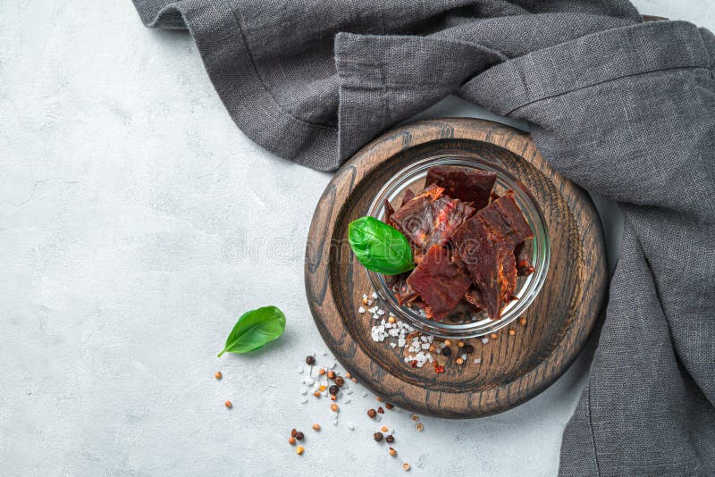Appetizer Made from Natural Beef Meat with Spices and Basil on a Gray