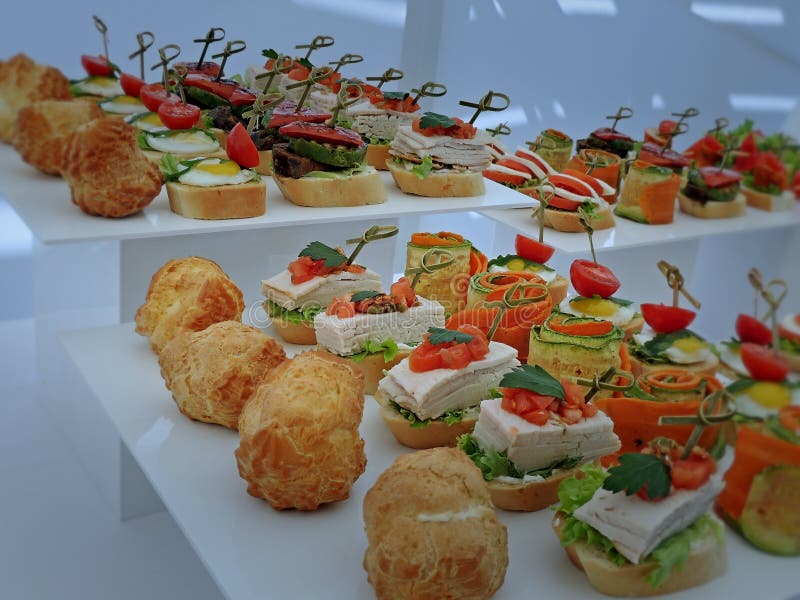 Set Of Appetizer Table Settings On The Plates On White Shelves Stock