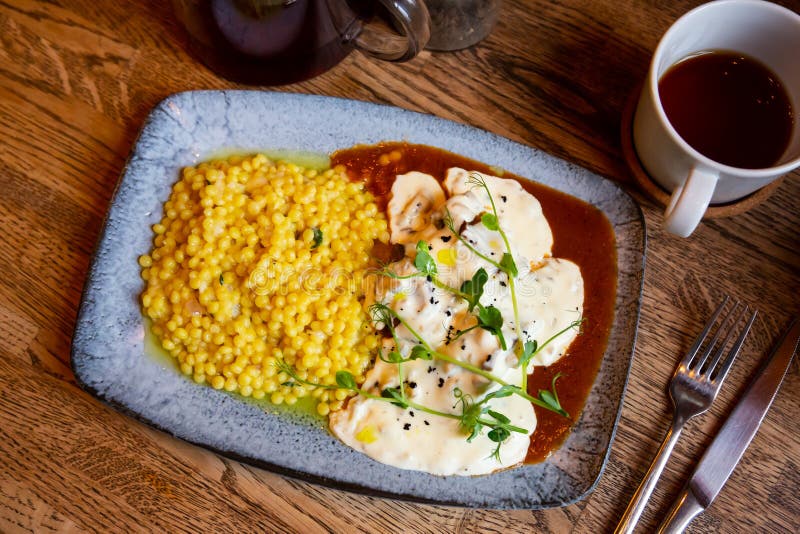Beef Cheeks with Ptitim Pasta Under Creamy Mushroom Sauce Stock Photo