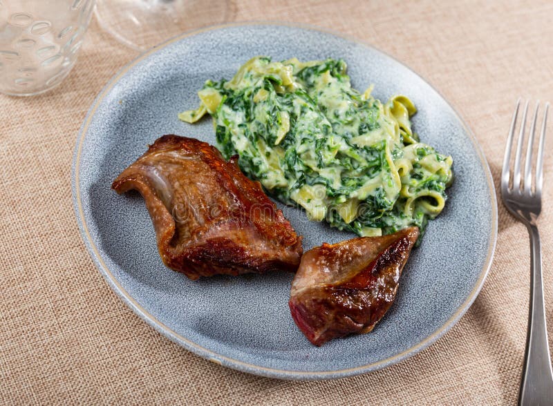Fried pieces of beef served with pasta stock photography