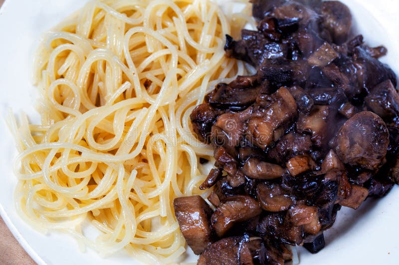 Appetizing pasta spaghetti with wild forest mushrooms close up royalty free stock photography