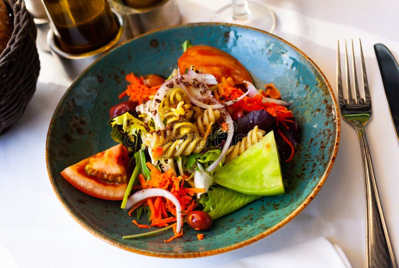 Appetizing salad with vegetables and pasta stock photo