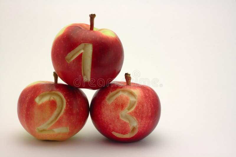 Numbers carved to 3 red apples. Numbers carved to 3 red apples