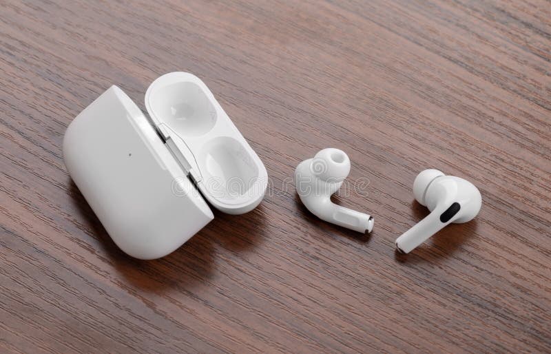 Apple AirPods Pro on a wooden table.