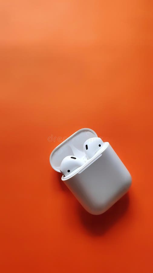 White Apple airpods, in Orange background, airpods with case in a background, headphones Wallpaper photos.