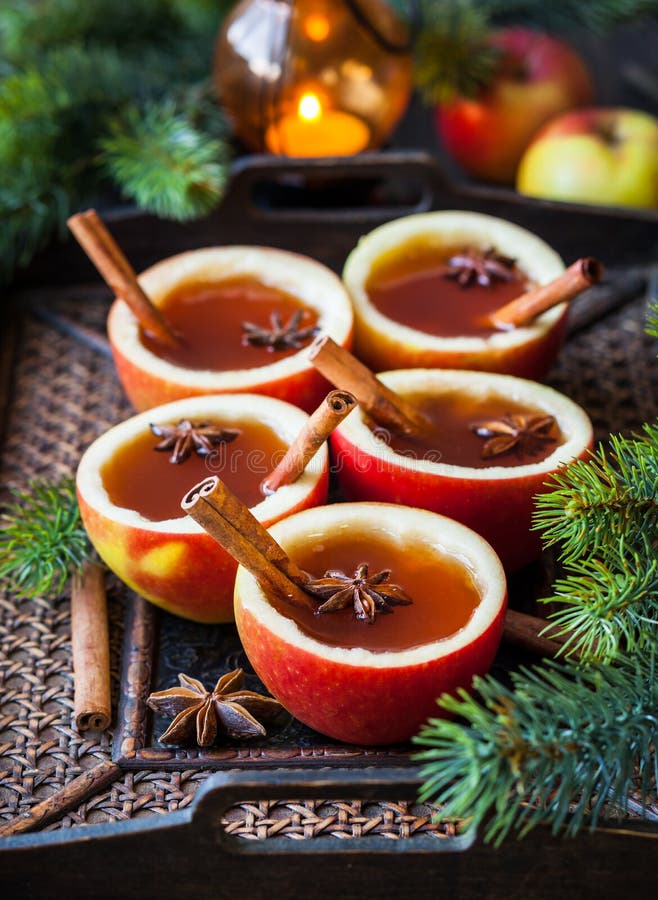 Apple Cider Cocktail with Red Oranges and Spices in Glasses and Jug on