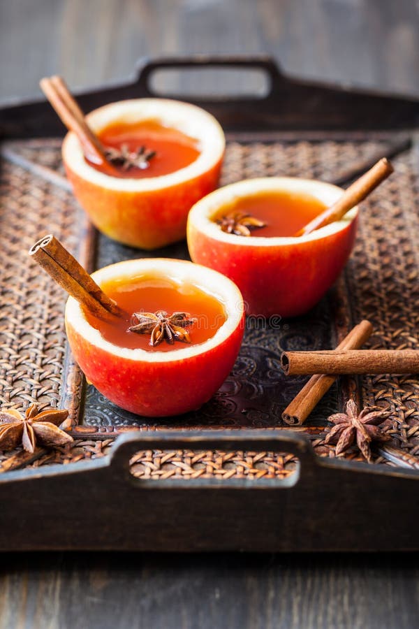 Apple Cider Cocktail with Red Oranges and Spices in Glasses and Jug on