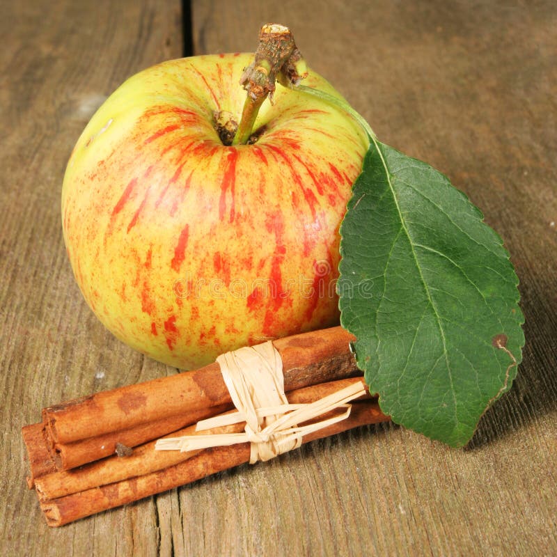 Apple and cinnamon on wood