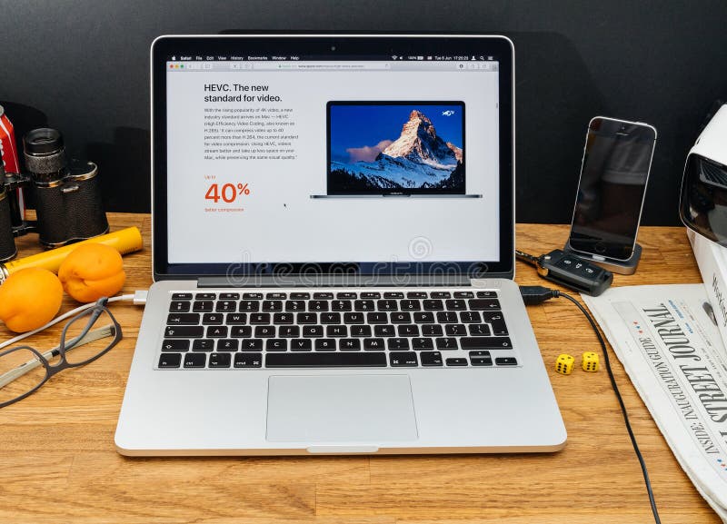 PARIS, FRANCE - JUNE 6, 2017: Apple Computers website on MacBook Retina in creative environment showcasing latest macOS High Sierra from Apple at WWDC 2017 - HEVC h.265 for video files in OS. PARIS, FRANCE - JUNE 6, 2017: Apple Computers website on MacBook Retina in creative environment showcasing latest macOS High Sierra from Apple at WWDC 2017 - HEVC h.265 for video files in OS