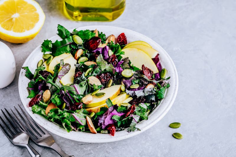 Apple Cranberry Kale Salad bowl with dry cranberries, almonds and pumpkin seeds