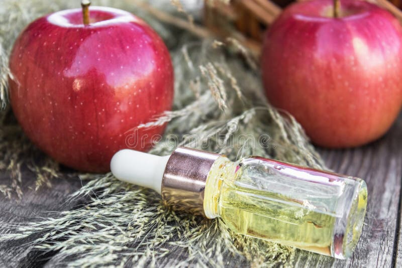 Apple Essential Oil on a Wooden Table Near Ripe Red Apples. Essential Oil  is Used To Fill Lamps, Perfumes and in Cosmetics Stock Photo - Image of  hygiene, herbal: 163070280