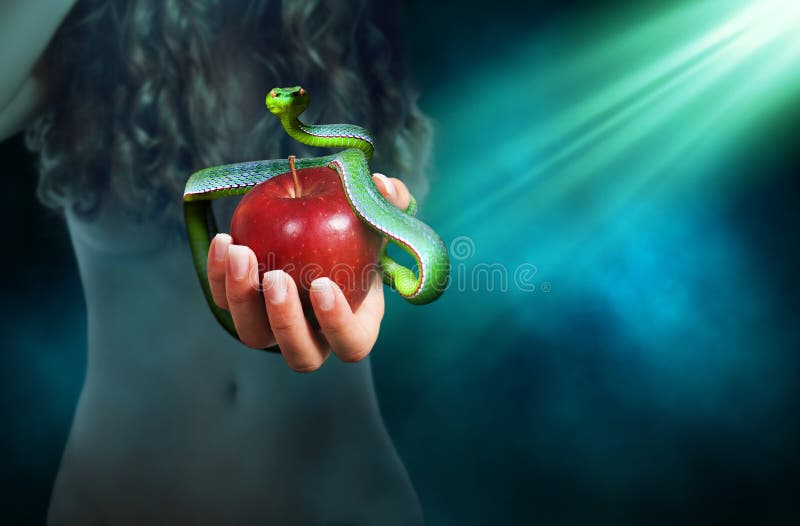 Apple fruit in a hand of a woman with a snake on top of it