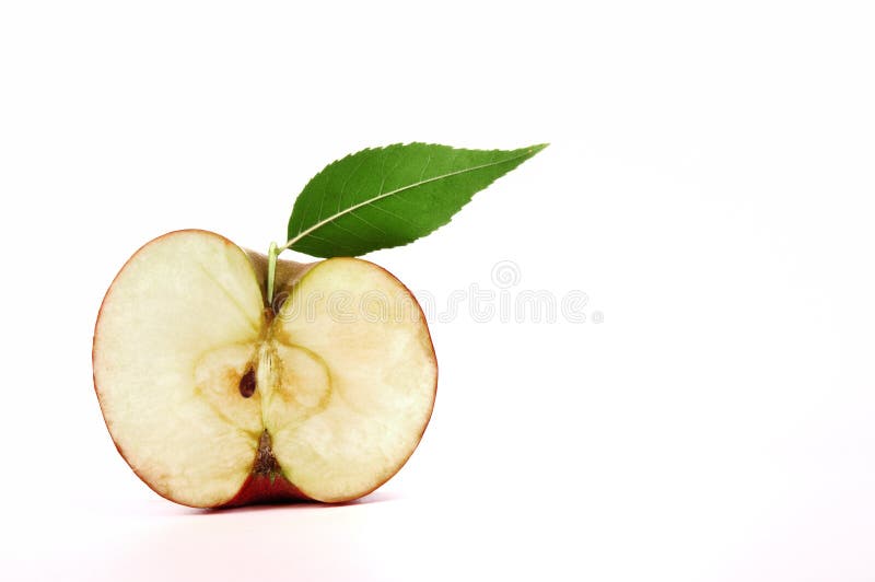 Apple with Green Leaf, Cut in Half on White Stock Image - Image of