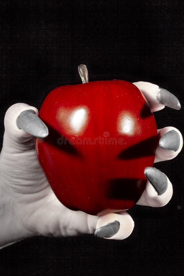 Apple in the hands with claws