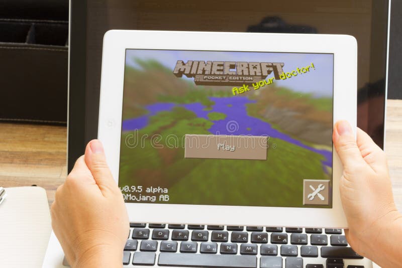 WARSZAWA, POLAND - OCTOBER 10, 2014. Minecraft game on Apple white iPad. On September 15, 2014, Microsoft announced a deal to purchase the game's developer, Mojang, granting the company ownership of the game's intellectual property. The all-cash deal is worth $2.5 billion. WARSZAWA, POLAND - OCTOBER 10, 2014. Minecraft game on Apple white iPad. On September 15, 2014, Microsoft announced a deal to purchase the game's developer, Mojang, granting the company ownership of the game's intellectual property. The all-cash deal is worth $2.5 billion.