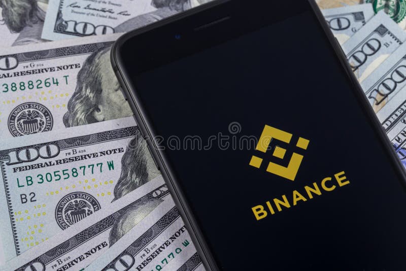 Apple iPhone and Binance logo, and dollars. Binance is a cryptocurrency exchange. Ekaterinburg, Russia - April 11, 2018 royalty free stock photography