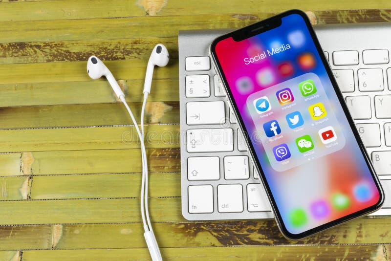 Apple iPhone X with icons of social media facebook, instagram, twitter, snapchat application on screen. Social media icons. Social