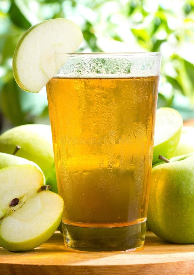 Apple Juice Pouring from Bottle into Glass Jar Stock Image Image of