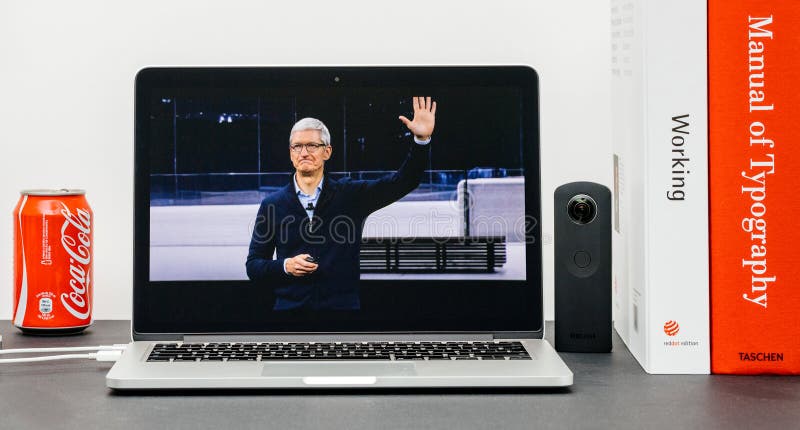 PARIS, FRANCE - SEP 13, 2017: Minimalist creative room with Safari Browser open on MacBook Pro laptop showcasing Apple Keynote website with Tim Cook Apple CEO waving goodbye with hand. PARIS, FRANCE - SEP 13, 2017: Minimalist creative room with Safari Browser open on MacBook Pro laptop showcasing Apple Keynote website with Tim Cook Apple CEO waving goodbye with hand