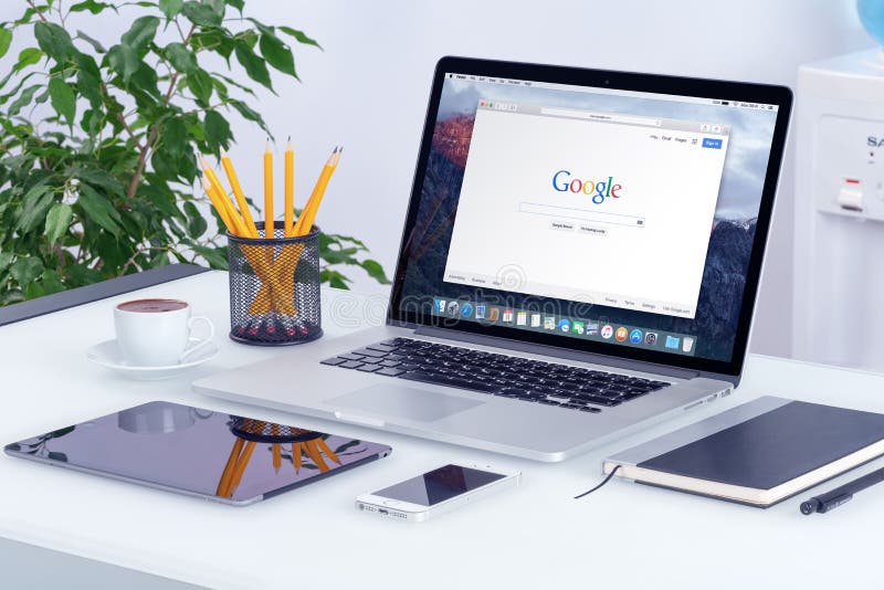 Apple MacBook Pro on desk with Google search web page stock photos Apple MacBook Pro on desk with Google search web page stock photos