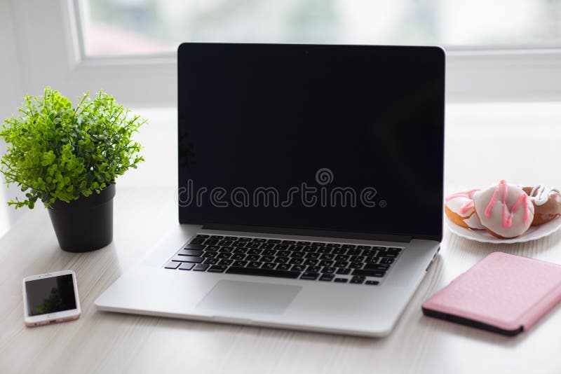 Apple notebook MacBook Pro and iPhone 6S Rose Gold stock images